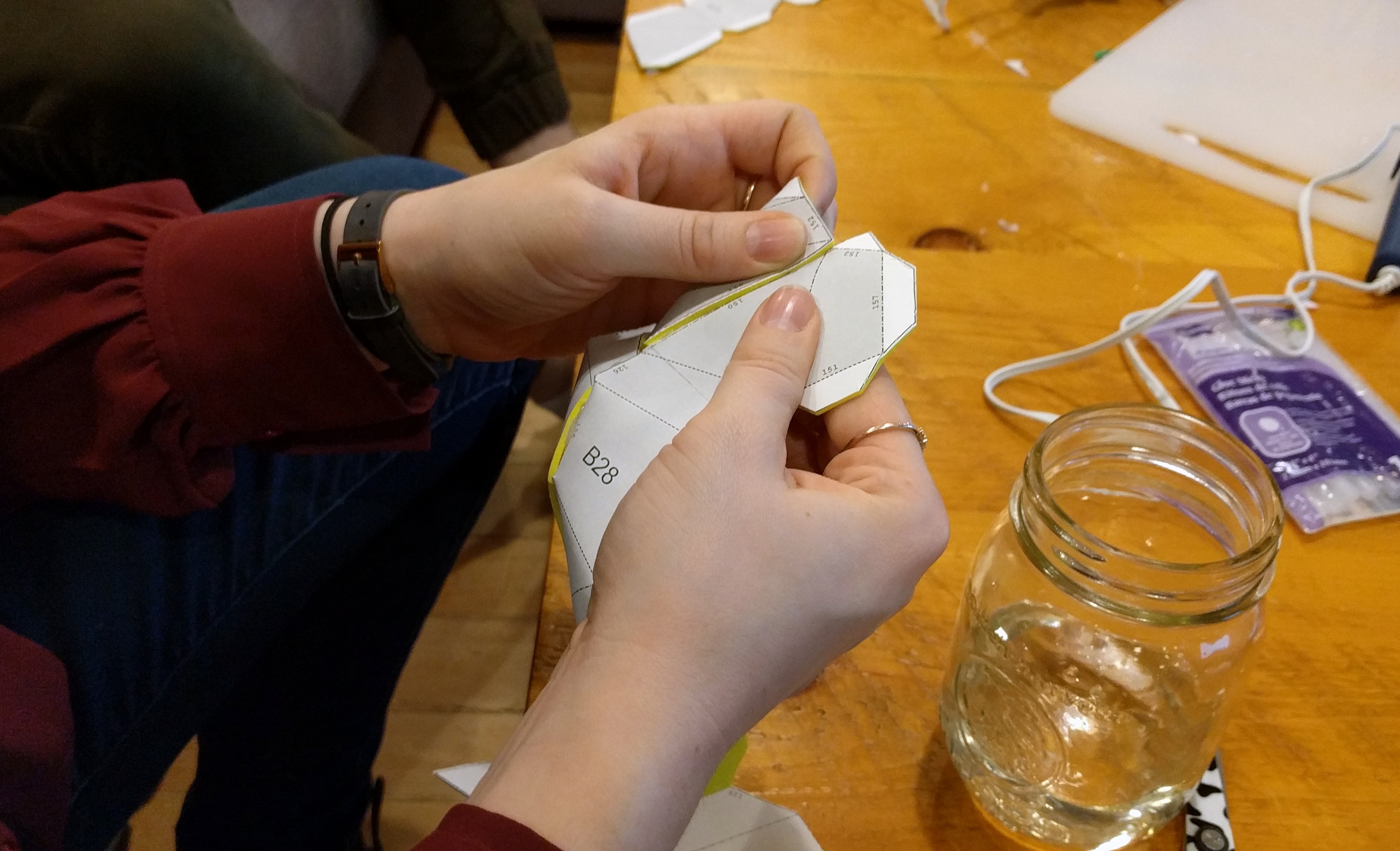 Hands-gluing-foam-pieces-together